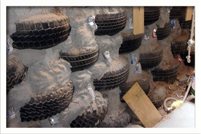 Filled tires stacked in the northern section of the home create structure and thermal mass